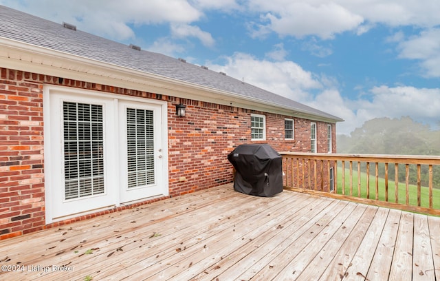 wooden terrace with a grill