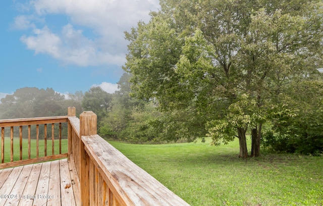 wooden deck featuring a yard