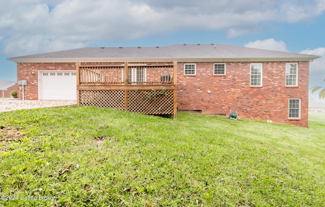 back of house with a yard, a garage, and a wooden deck