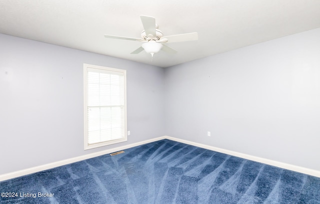 carpeted empty room featuring ceiling fan