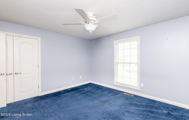 carpeted empty room with ceiling fan