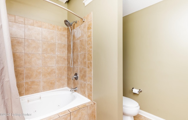 bathroom with toilet and shower / tub combo