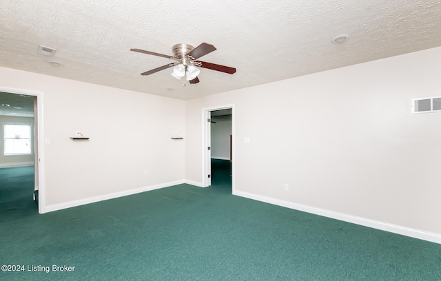 unfurnished room featuring dark colored carpet, a textured ceiling, and ceiling fan