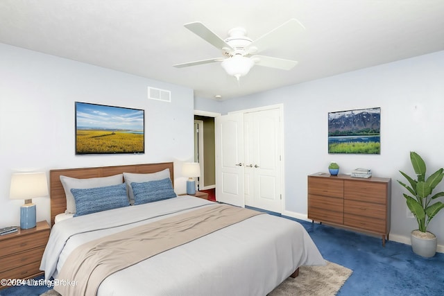 carpeted bedroom featuring ceiling fan and a closet