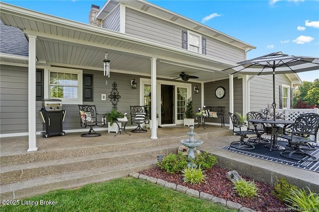 264 Cedarwood Rd, Bedford, KY 40006 - exterior space with a porch, ceiling fan, a chimney, outdoor dining space, and a patio