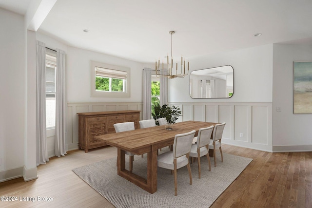 dining area featuring light hardwood / wood-style floors and a chandelier