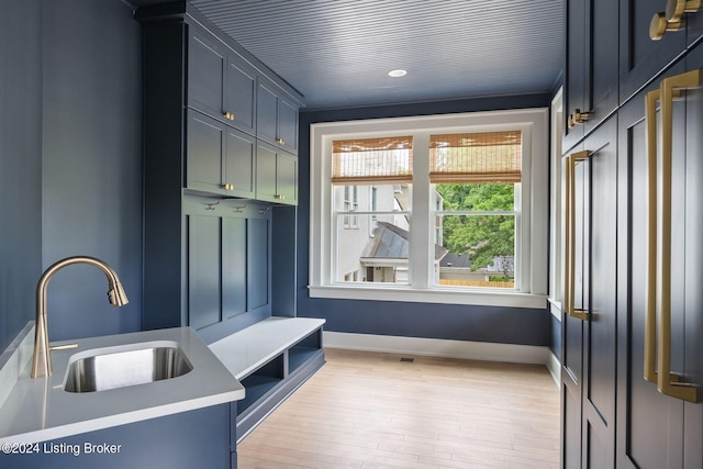 mudroom with light wood-type flooring and sink