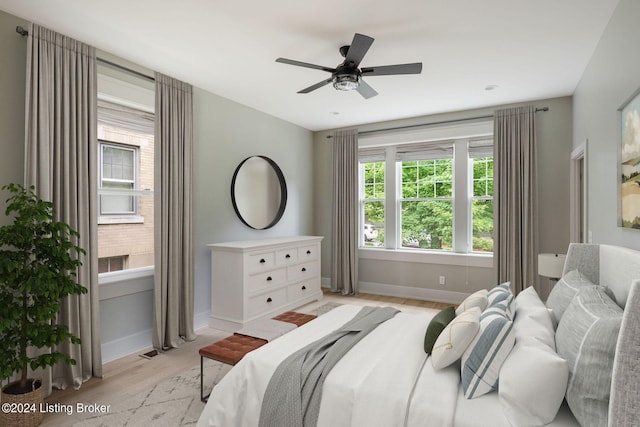 bedroom with light hardwood / wood-style flooring and ceiling fan