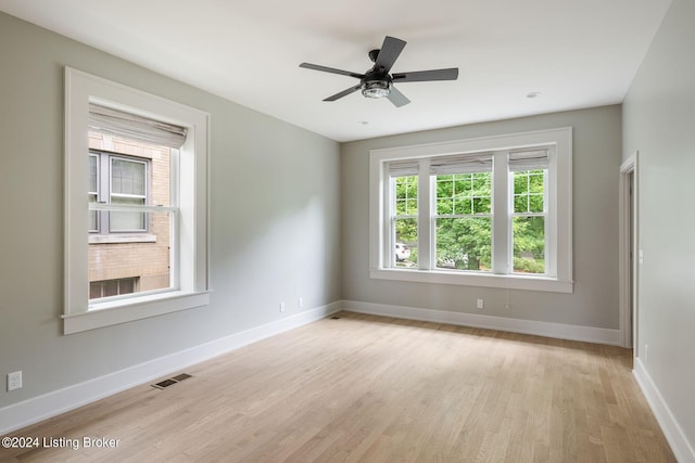 spare room with light wood-type flooring and ceiling fan