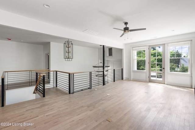 empty room with ceiling fan and light hardwood / wood-style floors