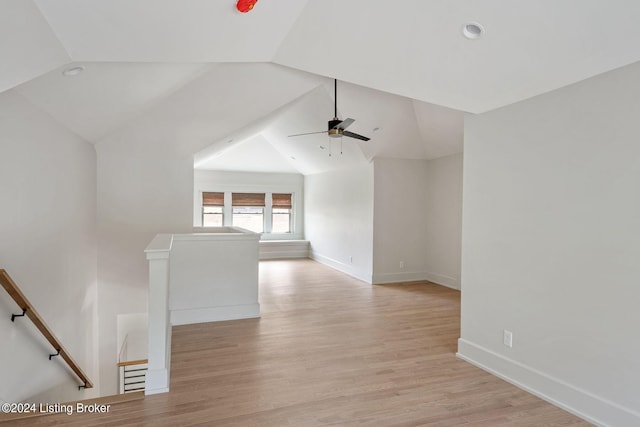 interior space with ceiling fan, vaulted ceiling, and light hardwood / wood-style floors