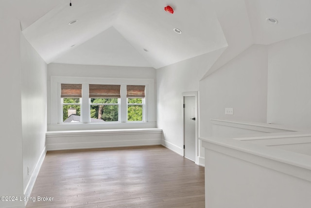 empty room with lofted ceiling and hardwood / wood-style floors