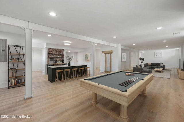 rec room with a brick fireplace, ornate columns, light wood-type flooring, and pool table