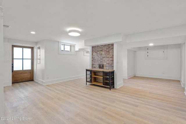 basement with light hardwood / wood-style flooring