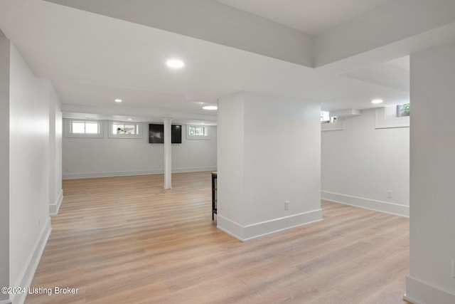 basement with light wood-type flooring and plenty of natural light