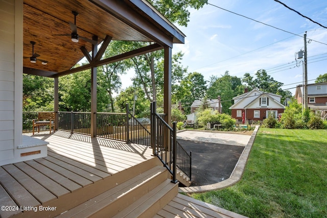 deck featuring a lawn and a patio area