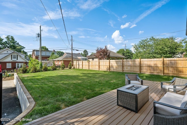 wooden terrace featuring a yard