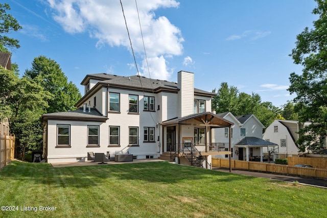 back of property with a patio, a gazebo, and a yard