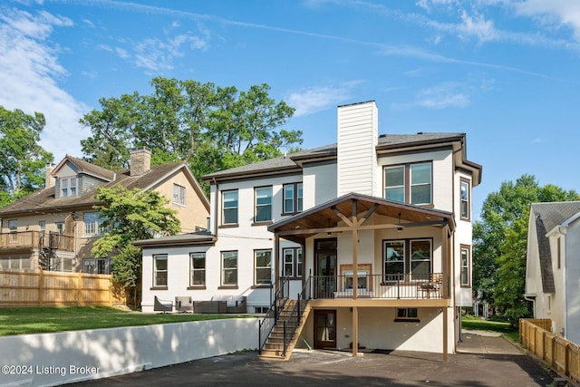 rear view of house with ceiling fan