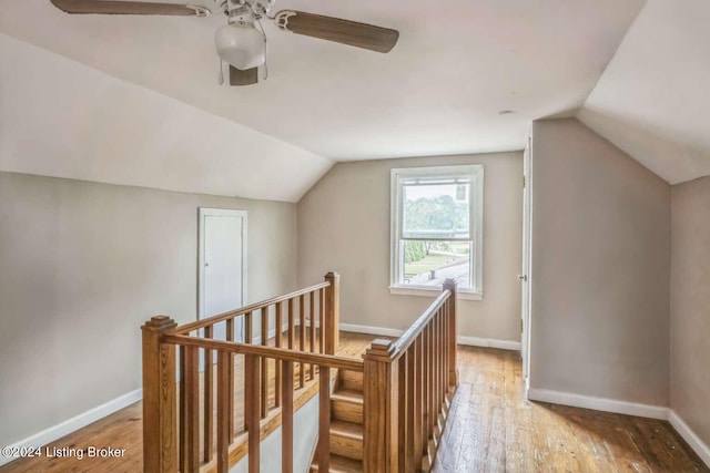 additional living space featuring wood-type flooring, vaulted ceiling, and ceiling fan