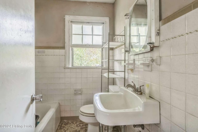 bathroom with toilet, sink, a bathing tub, tile walls, and tile patterned flooring