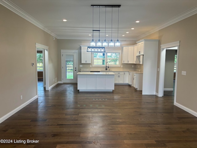 kitchen featuring white cabinets, dark hardwood / wood-style floors, a kitchen island, and hanging light fixtures