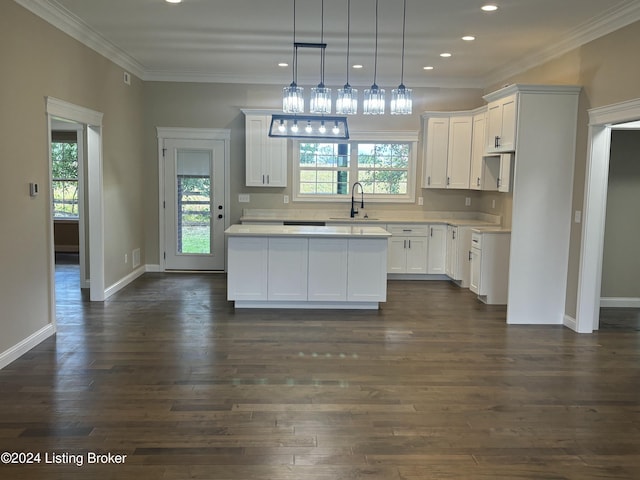 kitchen with crown molding, pendant lighting, a center island, dark hardwood / wood-style floors, and white cabinetry