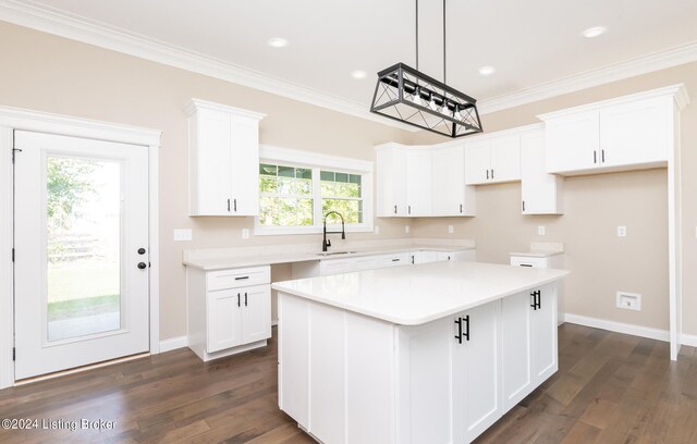 kitchen featuring a center island, white cabinetry, and plenty of natural light