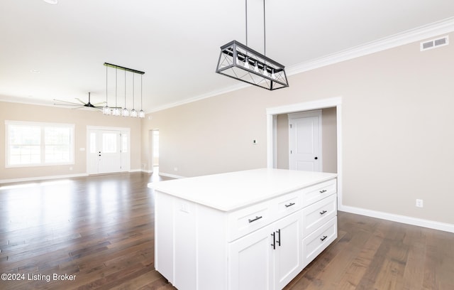 kitchen featuring white cabinetry, a center island, dark wood-type flooring, and decorative light fixtures