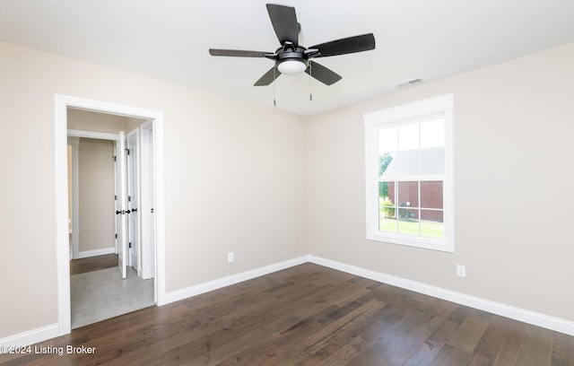 spare room with dark hardwood / wood-style floors and ceiling fan