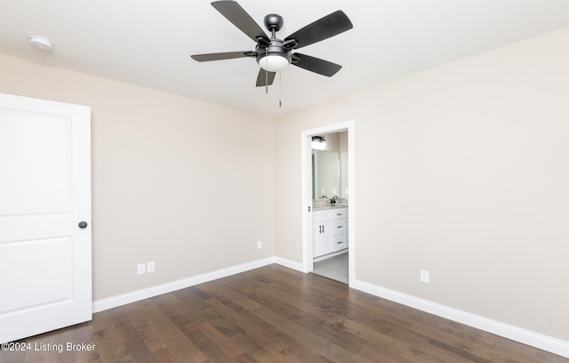 unfurnished bedroom with ensuite bath, ceiling fan, and dark hardwood / wood-style flooring