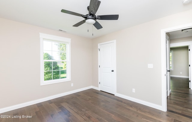 spare room featuring ceiling fan and dark hardwood / wood-style flooring