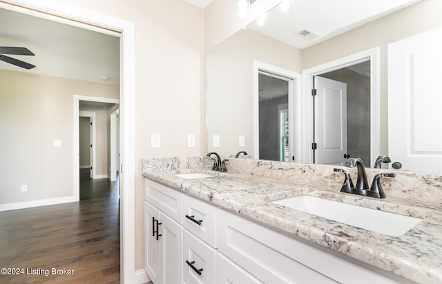 bathroom with hardwood / wood-style flooring, vanity, and ceiling fan