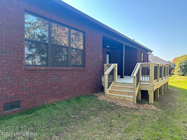 exterior space with a yard and a wooden deck