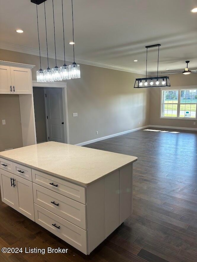 kitchen featuring white cabinetry, ceiling fan, pendant lighting, and dark hardwood / wood-style floors