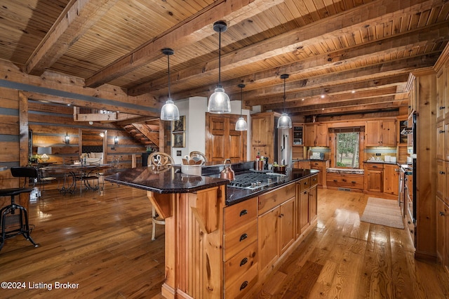 kitchen with beam ceiling, a large island, decorative light fixtures, wood ceiling, and hardwood / wood-style flooring