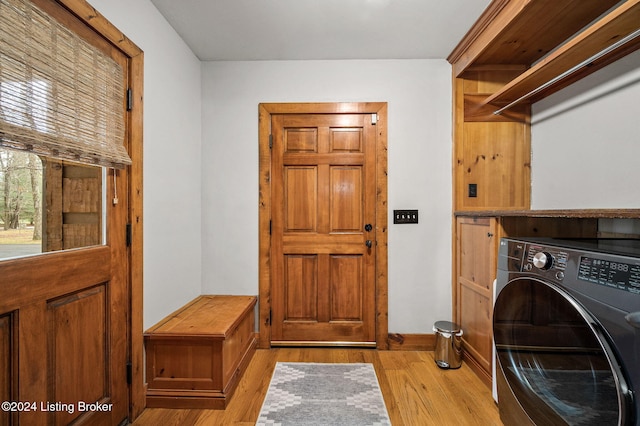 laundry room featuring washer / clothes dryer and light hardwood / wood-style floors