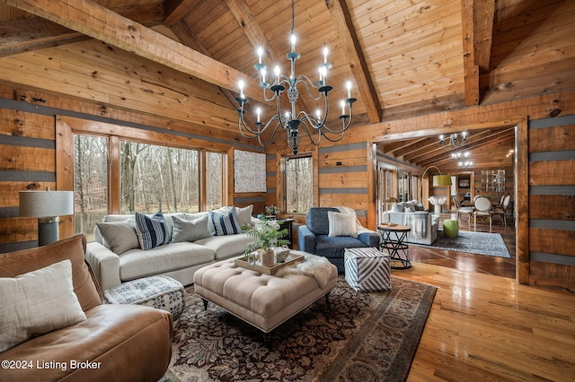 living room featuring hardwood / wood-style flooring, wooden walls, beamed ceiling, and an inviting chandelier