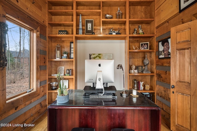 office space with wooden walls and hardwood / wood-style floors