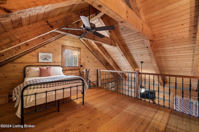 unfurnished bedroom with hardwood / wood-style floors, lofted ceiling with beams, wood walls, and wooden ceiling