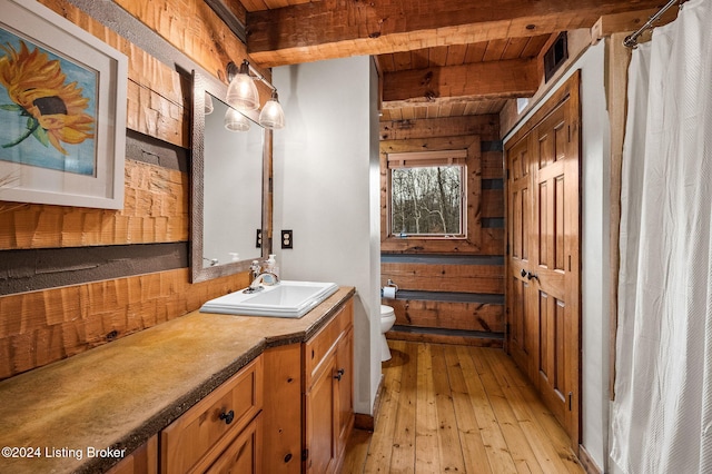 bathroom featuring wooden ceiling, beam ceiling, hardwood / wood-style flooring, and wooden walls