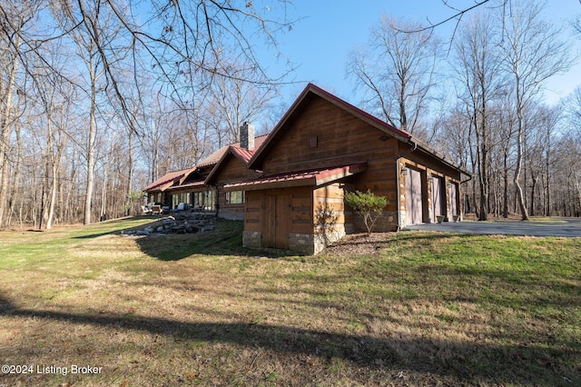 view of property exterior with a yard and a garage