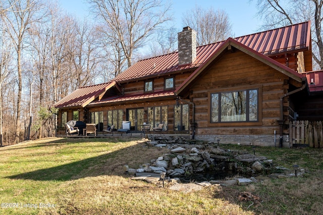 rear view of property featuring a yard