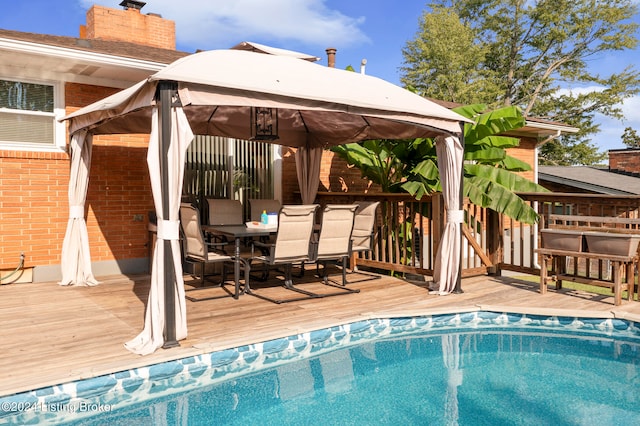 view of pool with a gazebo and a wooden deck