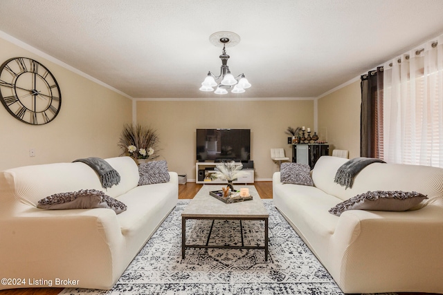 living room featuring an inviting chandelier, light wood-type flooring, and crown molding