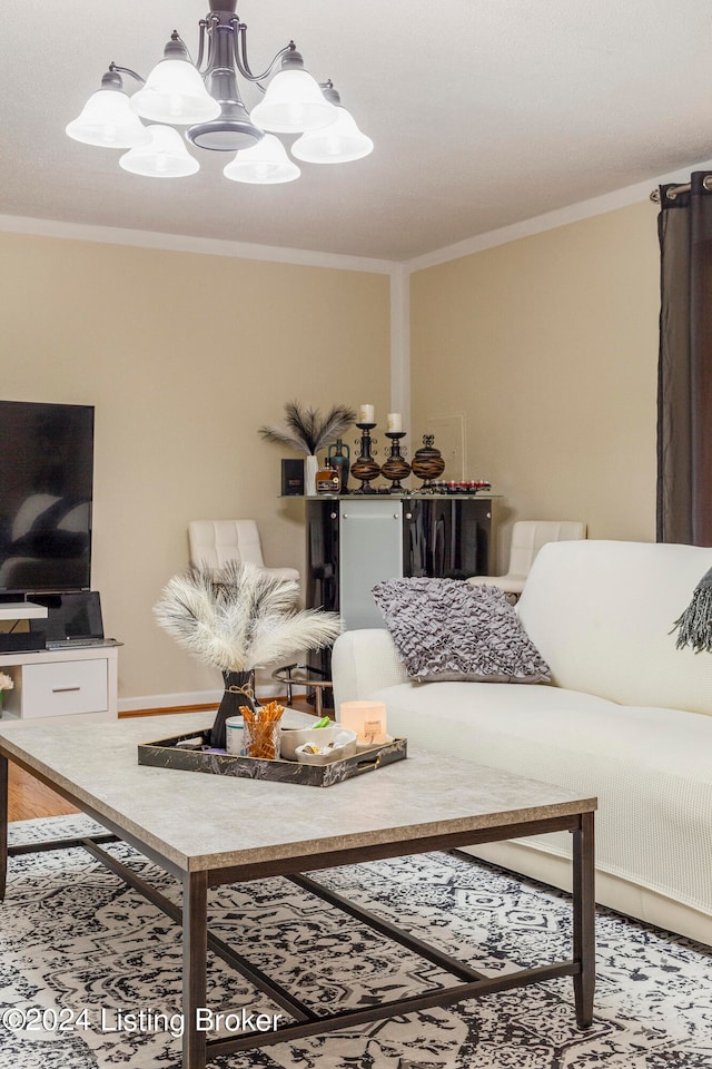 living room with crown molding, an inviting chandelier, and wood-type flooring