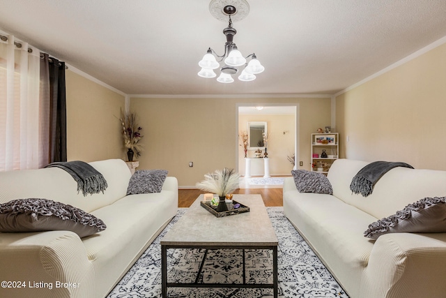 living room with crown molding, hardwood / wood-style floors, and a chandelier