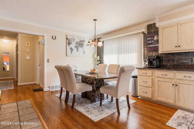 dining space featuring a notable chandelier and dark hardwood / wood-style flooring