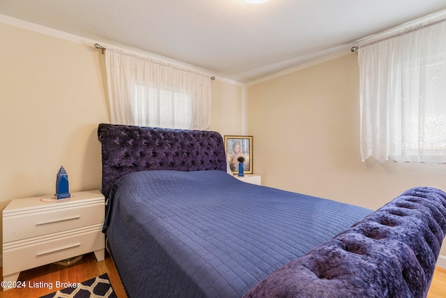 bedroom featuring crown molding and hardwood / wood-style floors