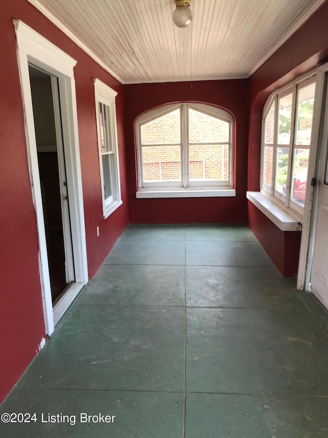 unfurnished sunroom featuring wood ceiling